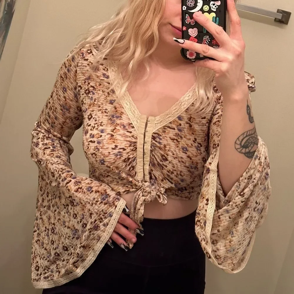 Free People cream and floral clasp front top w tie in front and bell sleeves